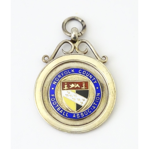 737 - Football Interest : A cased silver medal / fob with enamel decoration for Norfolk County Football As... 