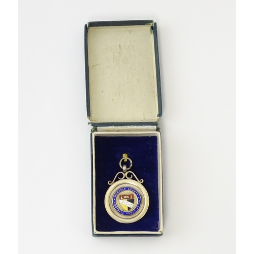 737 - Football Interest : A cased silver medal / fob with enamel decoration for Norfolk County Football As... 