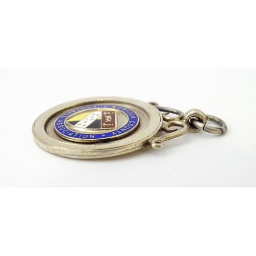 737 - Football Interest : A cased silver medal / fob with enamel decoration for Norfolk County Football As... 