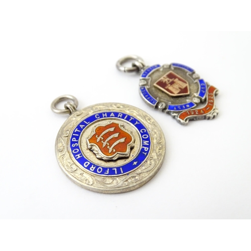 740 - Football Interest: Two silver and enamel fobs / medals, one for Ilford Hospital Charity Compt, the o... 