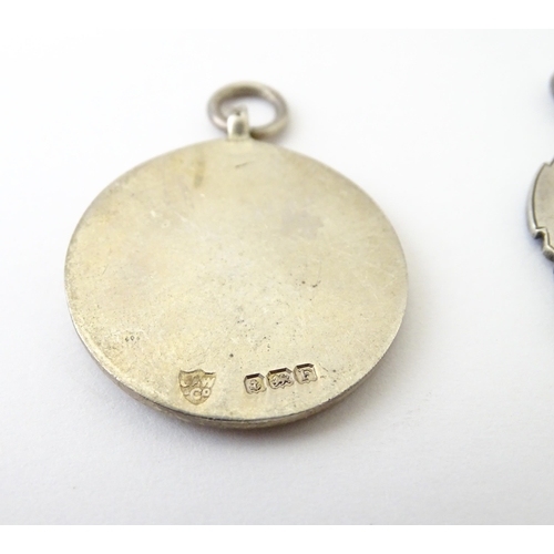 740 - Football Interest: Two silver and enamel fobs / medals, one for Ilford Hospital Charity Compt, the o... 