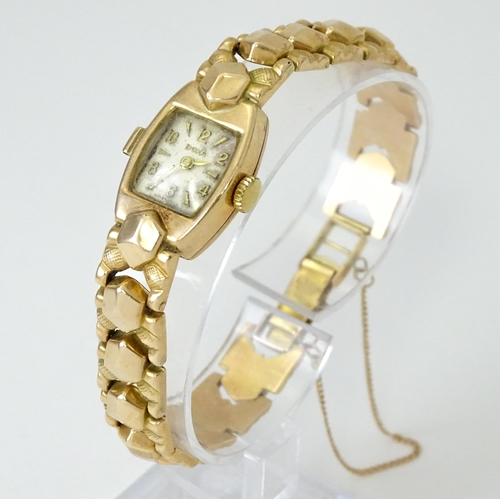 749 - A 14ct gold cased ladies wristwatch by Doxa with 14ct gold strap. Approx. 1/2