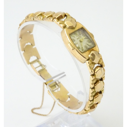 749 - A 14ct gold cased ladies wristwatch by Doxa with 14ct gold strap. Approx. 1/2