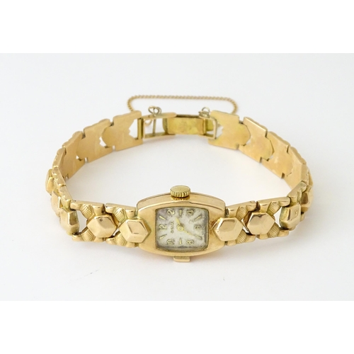 749 - A 14ct gold cased ladies wristwatch by Doxa with 14ct gold strap. Approx. 1/2