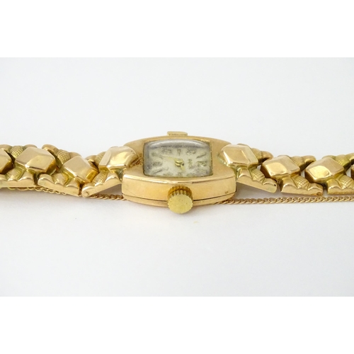 749 - A 14ct gold cased ladies wristwatch by Doxa with 14ct gold strap. Approx. 1/2