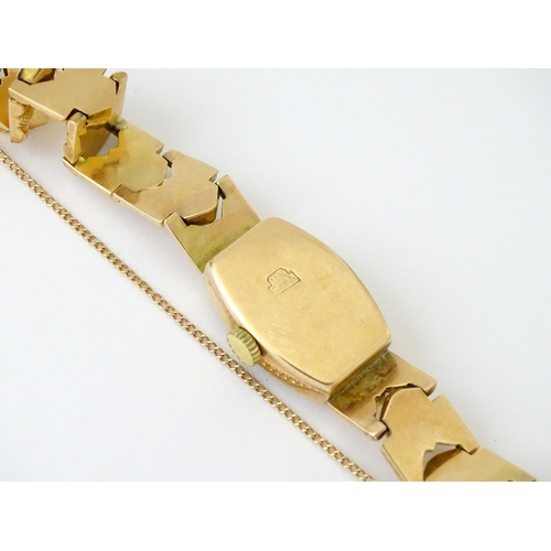 749 - A 14ct gold cased ladies wristwatch by Doxa with 14ct gold strap. Approx. 1/2