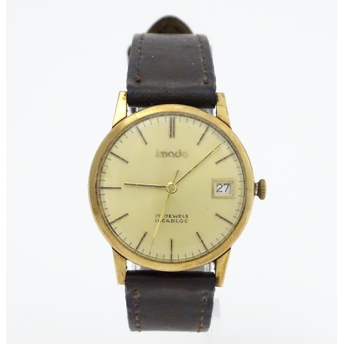 751 - A gentlemans 9ct gold cased Imado wristwatch with hour batons and date aperture, the case hallmarked... 