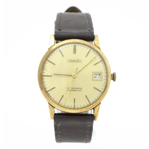 751 - A gentlemans 9ct gold cased Imado wristwatch with hour batons and date aperture, the case hallmarked... 