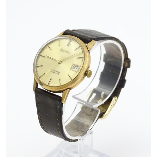 751 - A gentlemans 9ct gold cased Imado wristwatch with hour batons and date aperture, the case hallmarked... 