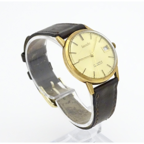 751 - A gentlemans 9ct gold cased Imado wristwatch with hour batons and date aperture, the case hallmarked... 