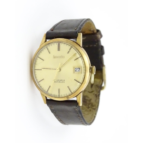 751 - A gentlemans 9ct gold cased Imado wristwatch with hour batons and date aperture, the case hallmarked... 