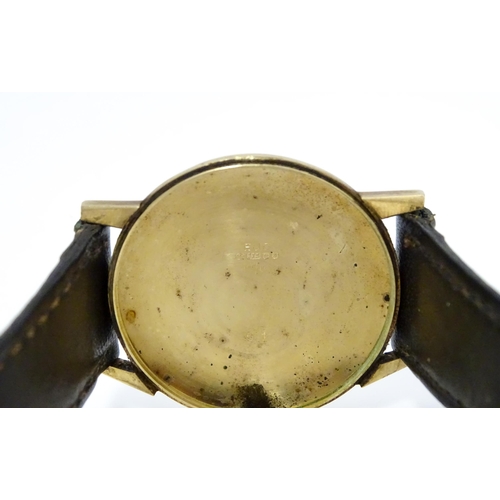 751 - A gentlemans 9ct gold cased Imado wristwatch with hour batons and date aperture, the case hallmarked... 