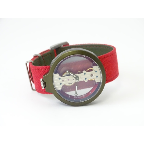 752 - A gentlemans Atto Verticale skeleton wristwatch with red strap. Approx. 1 5/8