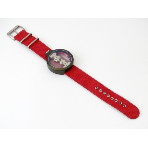 752 - A gentlemans Atto Verticale skeleton wristwatch with red strap. Approx. 1 5/8