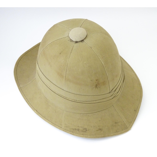 800 - Militaria : an early 20thC pith helmet by Linney, London, with khaki drill cotton exterior, the inte... 