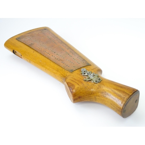 802 - Militaria : a 20thC cribbage board constructed from a gunstock, the top with affixed Royal Electrica... 