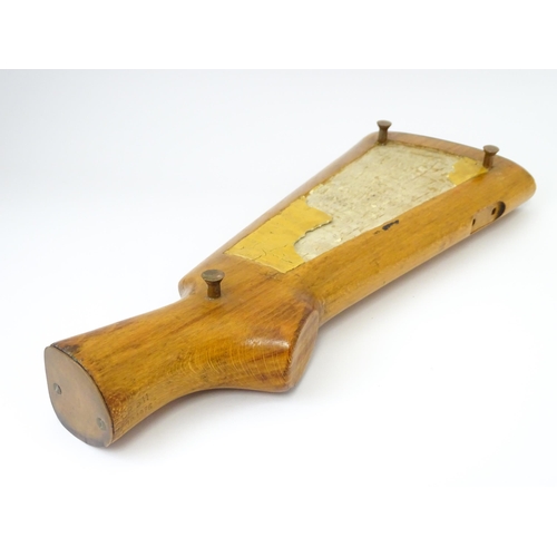 802 - Militaria : a 20thC cribbage board constructed from a gunstock, the top with affixed Royal Electrica... 