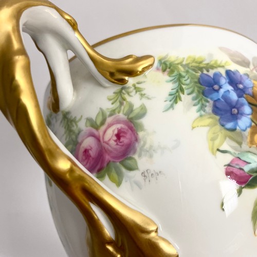 90 - A Cauldon loving cup with gilt highlights and hand painted decoration depicting flowers and foliage ... 