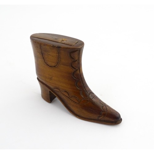 1200 - Treen : A 19thC novelty shoe snuff box of heeled boot form with carved decoration, the sliding lid o... 