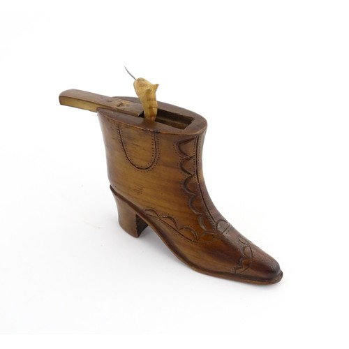 1200 - Treen : A 19thC novelty shoe snuff box of heeled boot form with carved decoration, the sliding lid o... 