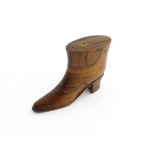 1200 - Treen : A 19thC novelty shoe snuff box of heeled boot form with carved decoration, the sliding lid o... 