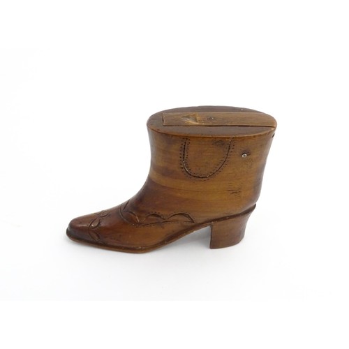 1200 - Treen : A 19thC novelty shoe snuff box of heeled boot form with carved decoration, the sliding lid o... 