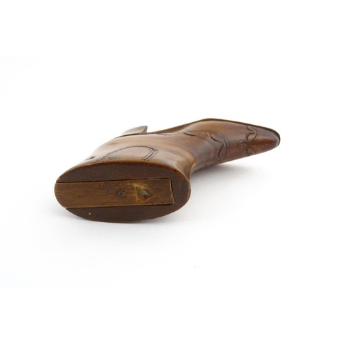 1200 - Treen : A 19thC novelty shoe snuff box of heeled boot form with carved decoration, the sliding lid o... 