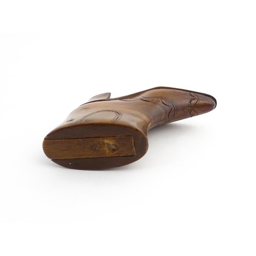 1200 - Treen : A 19thC novelty shoe snuff box of heeled boot form with carved decoration, the sliding lid o... 