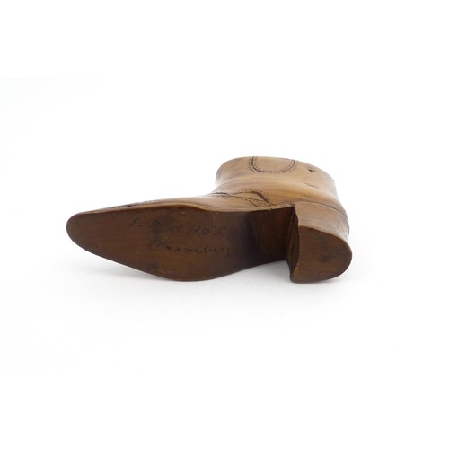 1200 - Treen : A 19thC novelty shoe snuff box of heeled boot form with carved decoration, the sliding lid o... 