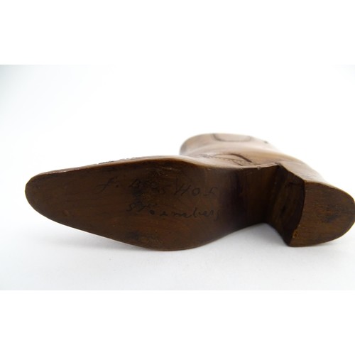 1200 - Treen : A 19thC novelty shoe snuff box of heeled boot form with carved decoration, the sliding lid o... 