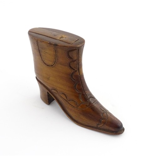 1200 - Treen : A 19thC novelty shoe snuff box of heeled boot form with carved decoration, the sliding lid o... 