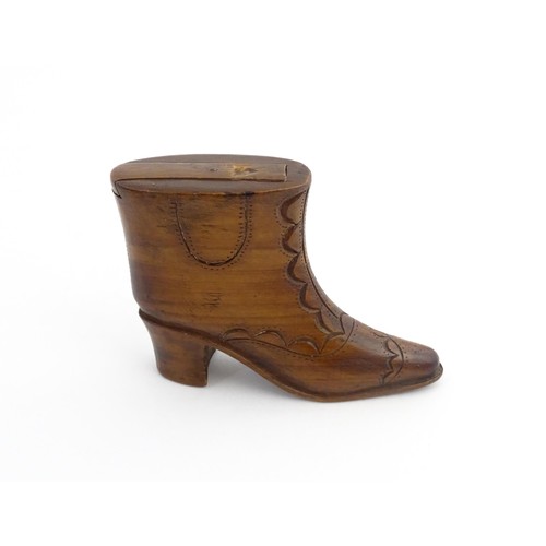 1200 - Treen : A 19thC novelty shoe snuff box of heeled boot form with carved decoration, the sliding lid o... 