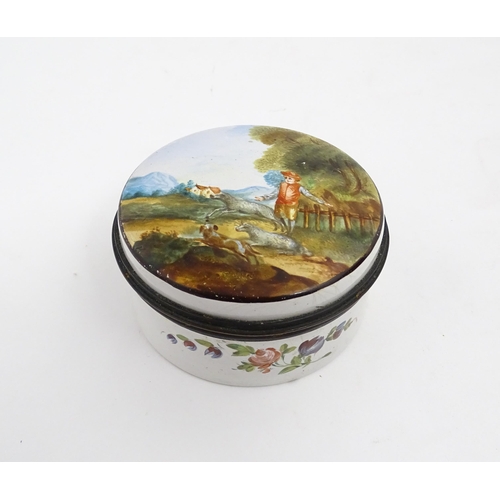 1284 - A 19thC enamel box of circular form with hand painted decoration depicting a country landscape with ... 