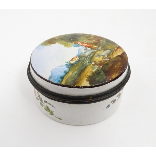 1284 - A 19thC enamel box of circular form with hand painted decoration depicting a country landscape with ... 