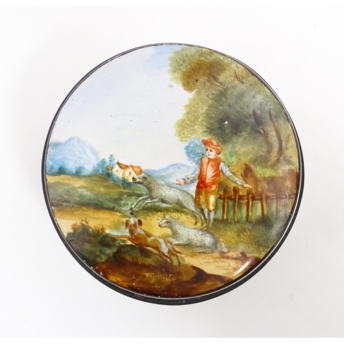 1284 - A 19thC enamel box of circular form with hand painted decoration depicting a country landscape with ... 