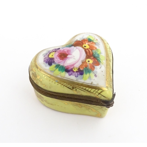 1285 - A 19thC porcelain trinket box of heart form with hand painted floral decoration. Approx. 2 1/4