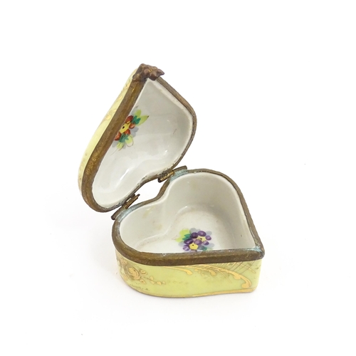 1285 - A 19thC porcelain trinket box of heart form with hand painted floral decoration. Approx. 2 1/4