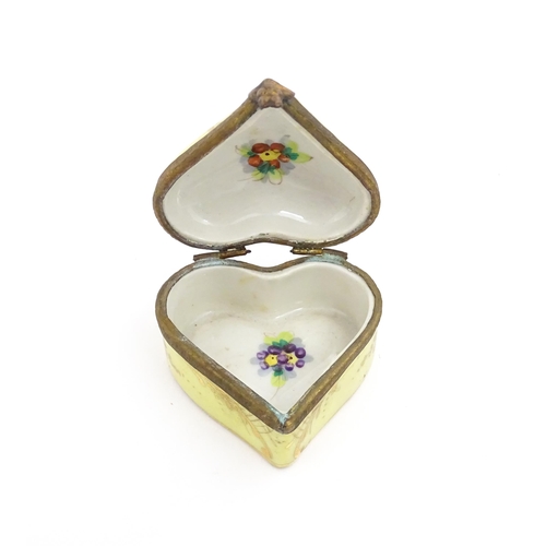 1285 - A 19thC porcelain trinket box of heart form with hand painted floral decoration. Approx. 2 1/4