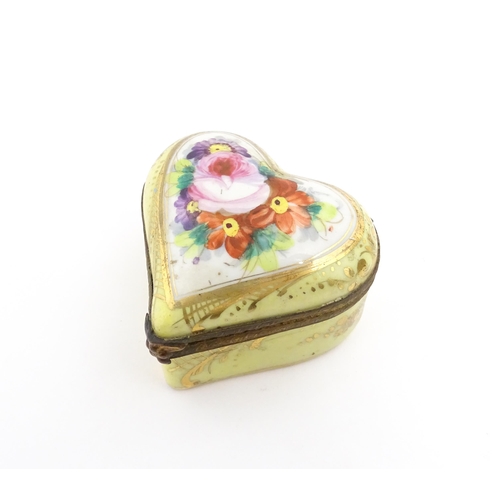 1285 - A 19thC porcelain trinket box of heart form with hand painted floral decoration. Approx. 2 1/4