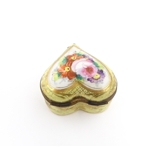 1285 - A 19thC porcelain trinket box of heart form with hand painted floral decoration. Approx. 2 1/4