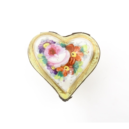 1285 - A 19thC porcelain trinket box of heart form with hand painted floral decoration. Approx. 2 1/4