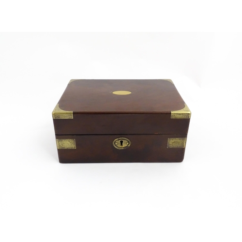 1288 - A 19thC brass bound mahogany vanity / dressing box with a fitted interior with glass dressing table ... 