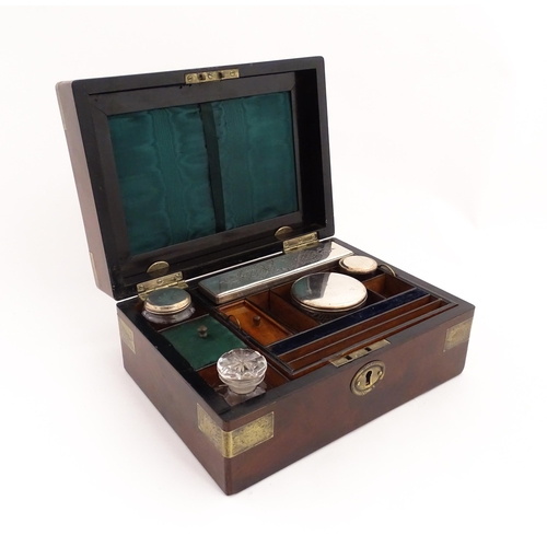 1288 - A 19thC brass bound mahogany vanity / dressing box with a fitted interior with glass dressing table ... 