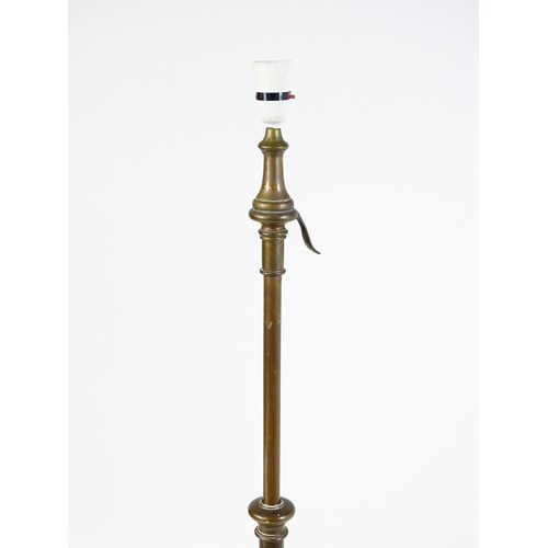 1553 - A c.1900 wrought iron standard lamp raised on four feet and decorated with wrought iron tendrils. Ma... 