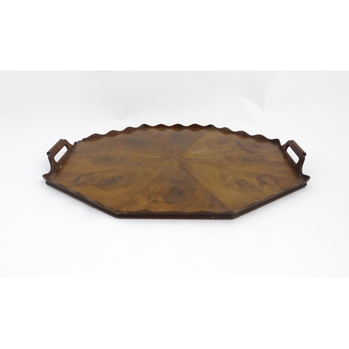 1300 - A 19thC yew wood tray of rectangular form with shaped gallery. Together with another of octagonal fo... 