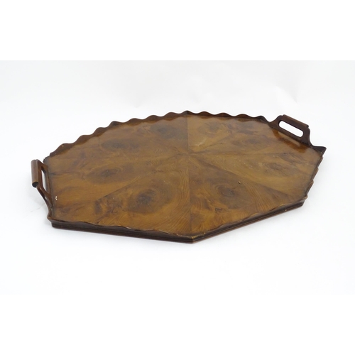 1300 - A 19thC yew wood tray of rectangular form with shaped gallery. Together with another of octagonal fo... 