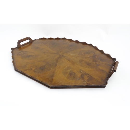 1300 - A 19thC yew wood tray of rectangular form with shaped gallery. Together with another of octagonal fo... 