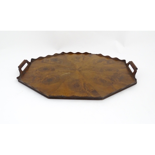 1300 - A 19thC yew wood tray of rectangular form with shaped gallery. Together with another of octagonal fo... 