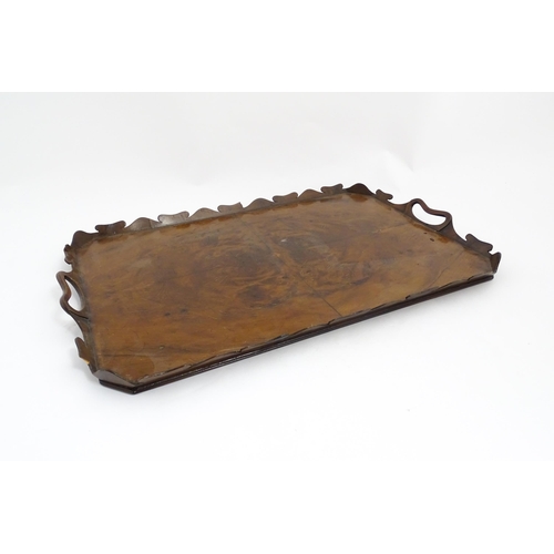 1300 - A 19thC yew wood tray of rectangular form with shaped gallery. Together with another of octagonal fo... 