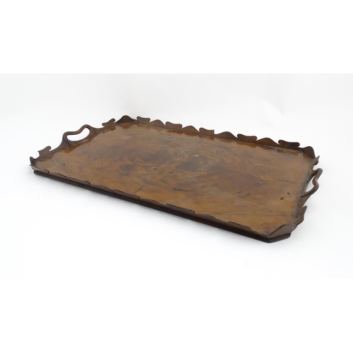 1300 - A 19thC yew wood tray of rectangular form with shaped gallery. Together with another of octagonal fo... 